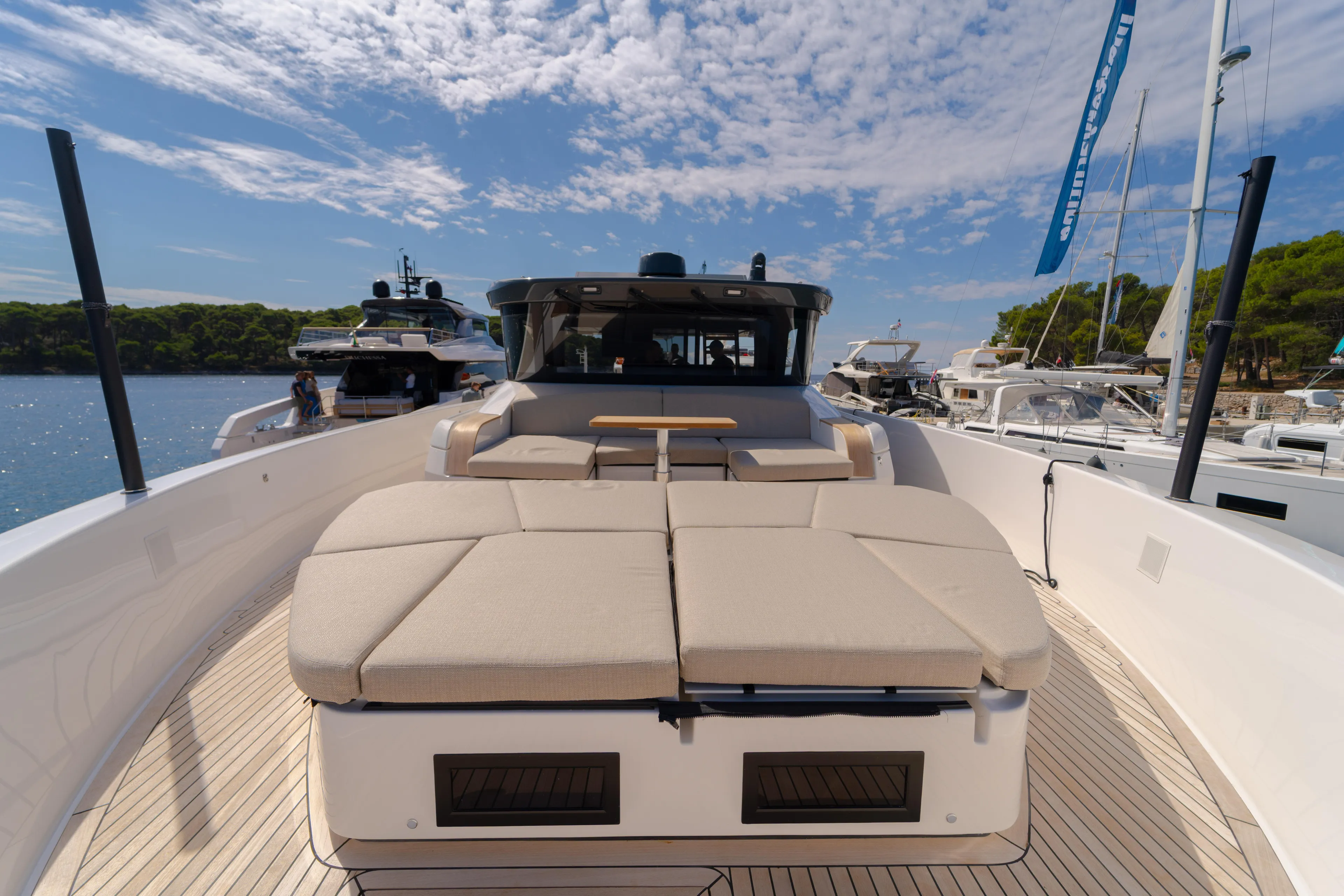  Yacht Photos Pics 2025 Bluegame BG74 yacht with spacious deck and luxurious seating under a clear sky.