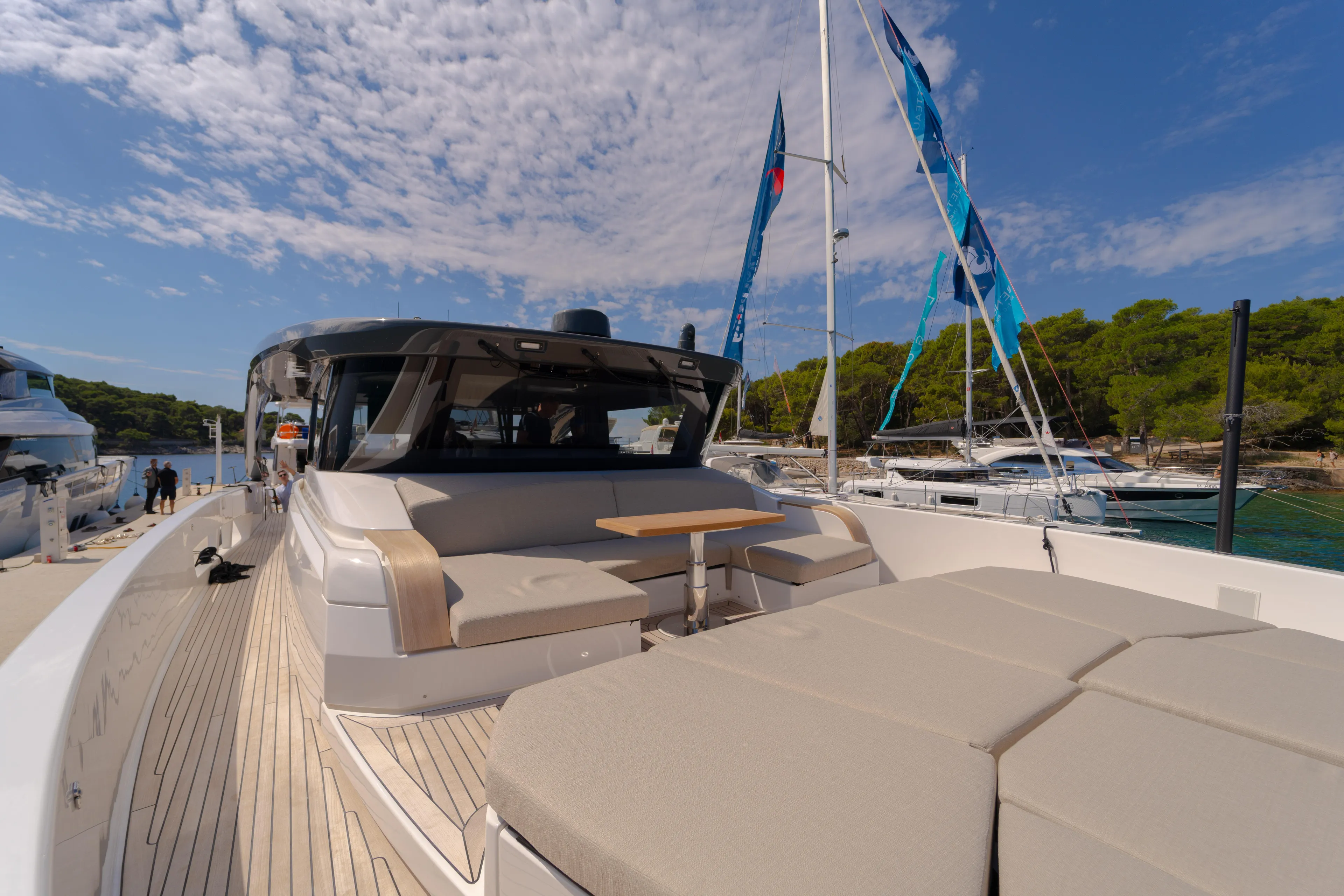  Yacht Photos Pics 2025 Bluegame BG74 yacht with spacious deck and modern design, docked by the sea.