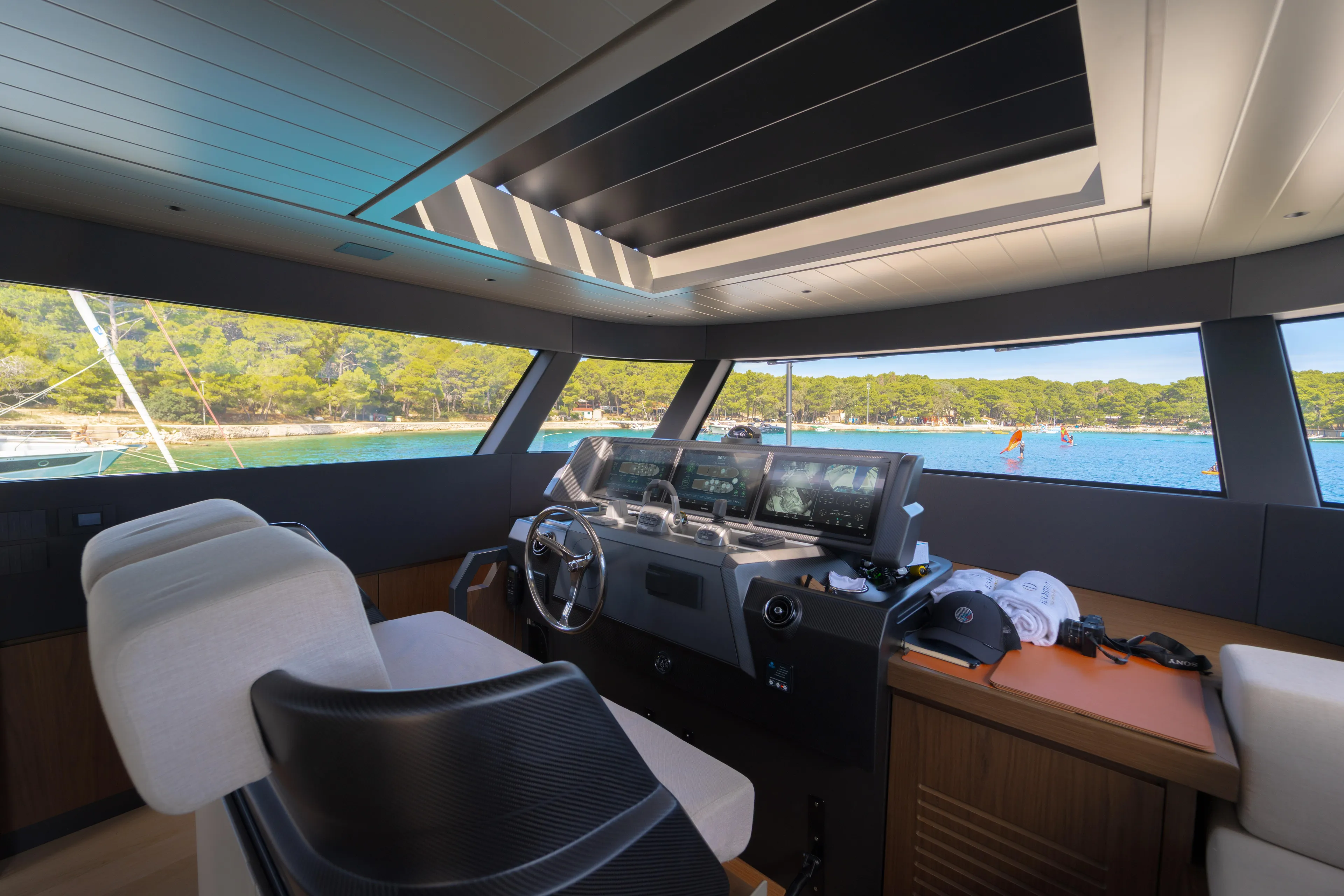  Yacht Photos Pics Interior of 2025 Bluegame BG74 yacht with modern helm and scenic ocean view.