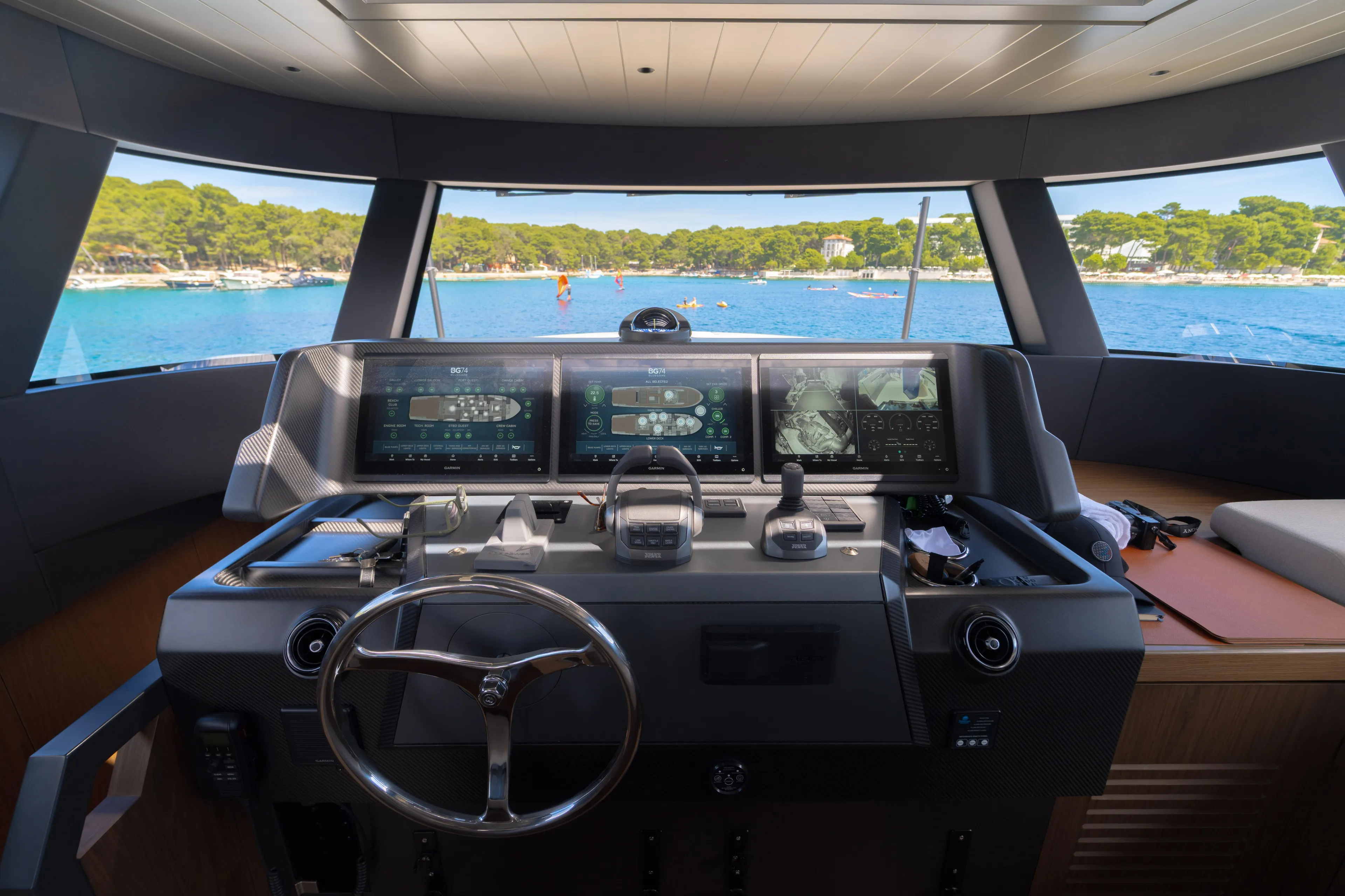  Yacht Photos Pics Helm of 2025 Bluegame BG74 yacht with advanced navigation displays and scenic ocean view.