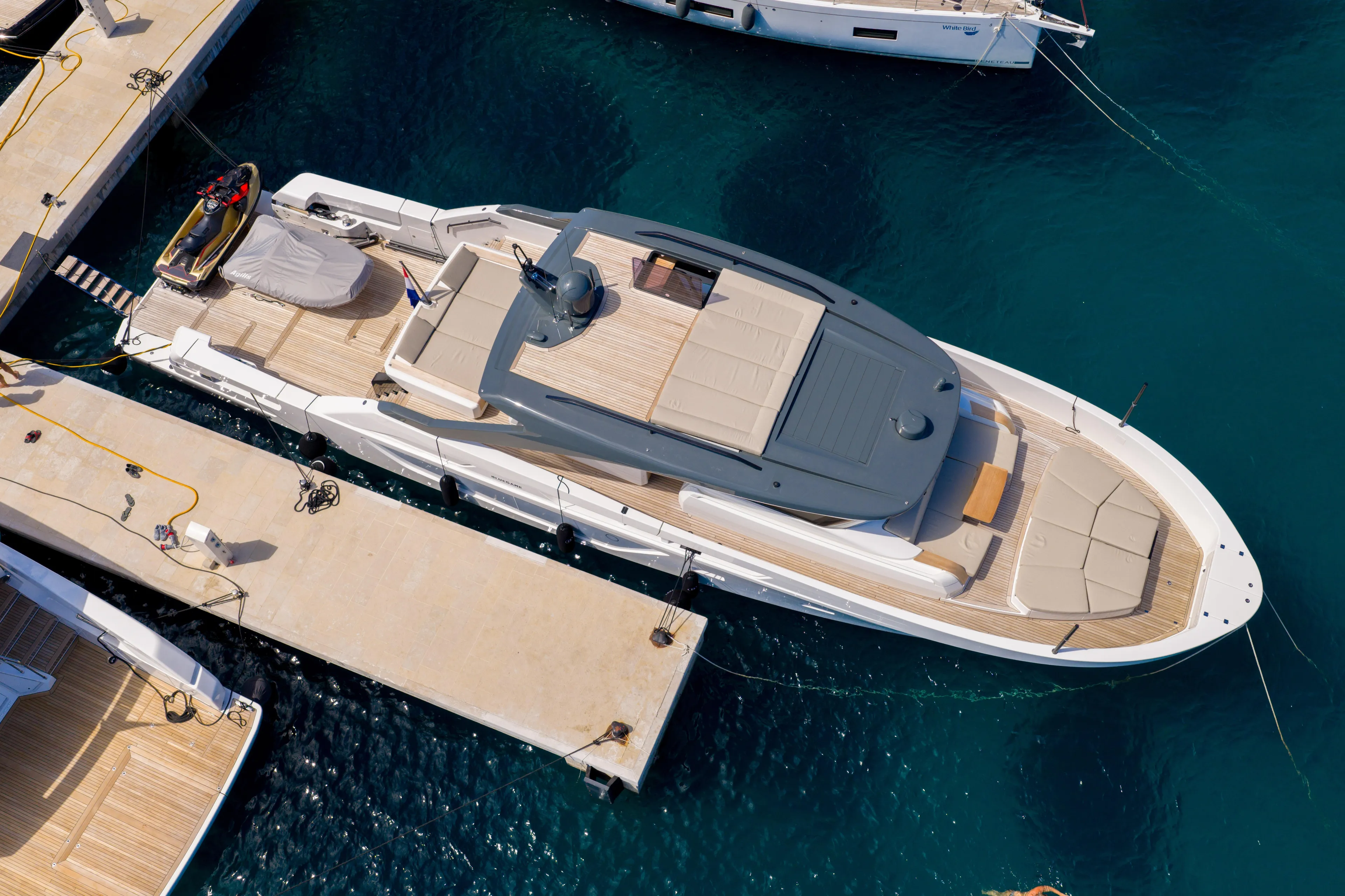  Yacht Photos Pics Aerial view of 2025 Bluegame BG74 yacht docked at marina.