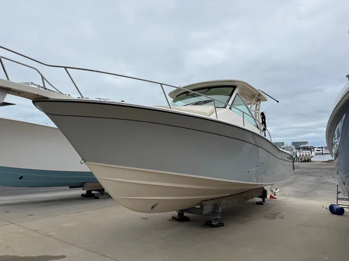  Yacht Photos Pics 2025 Grady-White Express 330 boat on dry dock, showcasing sleek design and sturdy build.