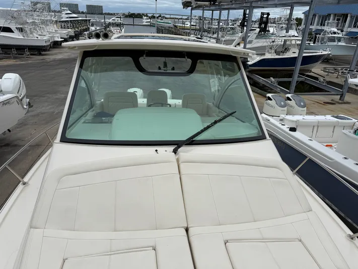  Yacht Photos Pics 2025 Grady-White Express 330 boat docked, showcasing spacious deck and windshield.