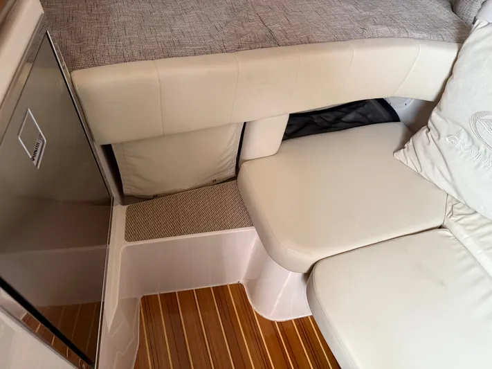  Yacht Photos Pics 2025 Grady-White Express 330 interior with beige seating and wooden flooring.