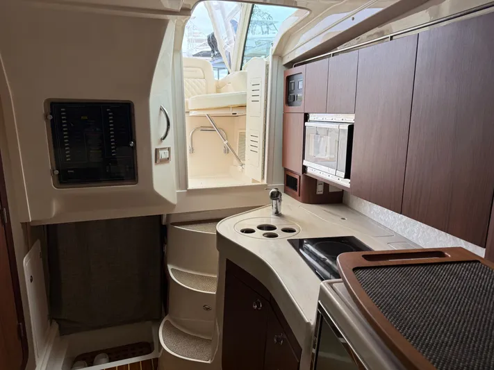  Yacht Photos Pics 2025 Grady-White Express 330 interior with modern kitchen and seating area.