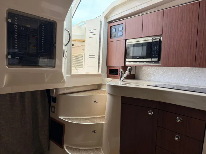  Yacht Photos Pics 2025 Grady-White Express 330 interior with modern kitchen and wooden cabinetry.