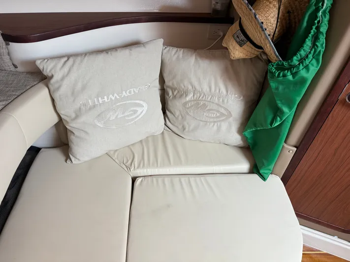  Yacht Photos Pics Interior of 2025 Grady-White Express 330 with branded cushions and a straw hat.