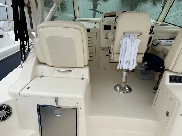  Yacht Photos Pics Interior of 2025 Grady-White Express 330 boat, featuring helm seats and storage compartments.