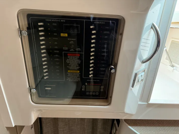  Yacht Photos Pics Electrical panel on a 2025 Grady-White Express 330 boat, featuring AC and DC switches.