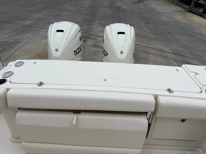  Yacht Photos Pics 2025 Grady-White Express 330 boat with twin Yamaha XTO V8 engines on a concrete surface.