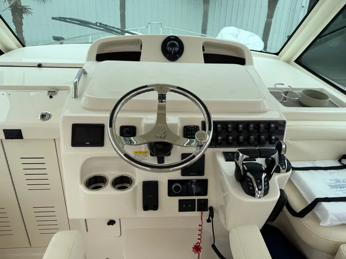  Yacht Photos Pics 2025 Grady-White Express 330 helm with steering wheel and control panel.