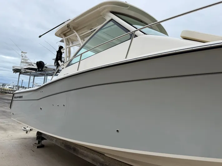  Yacht Photos Pics 2025 Grady-White Express 330 boat on a dock, showcasing sleek design and modern features.