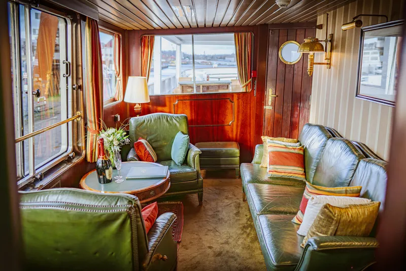 Sanssouci Star Yacht Photos Pics Luxurious 1982 Custom Displacement Twin Screw yacht interior with green leather seating and elegant decor.