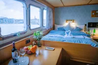 Luxurious cabin interior on 1982 Custom Displacement Twin Screw yacht with scenic window view.