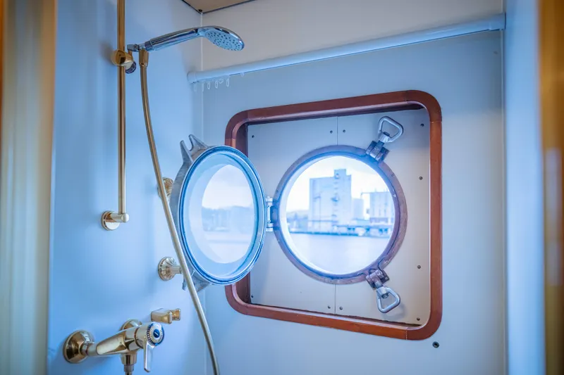 Sanssouci Star Yacht Photos Pics Shower area with brass fixtures and porthole window on a 1982 Custom Displacement Twin Screw.