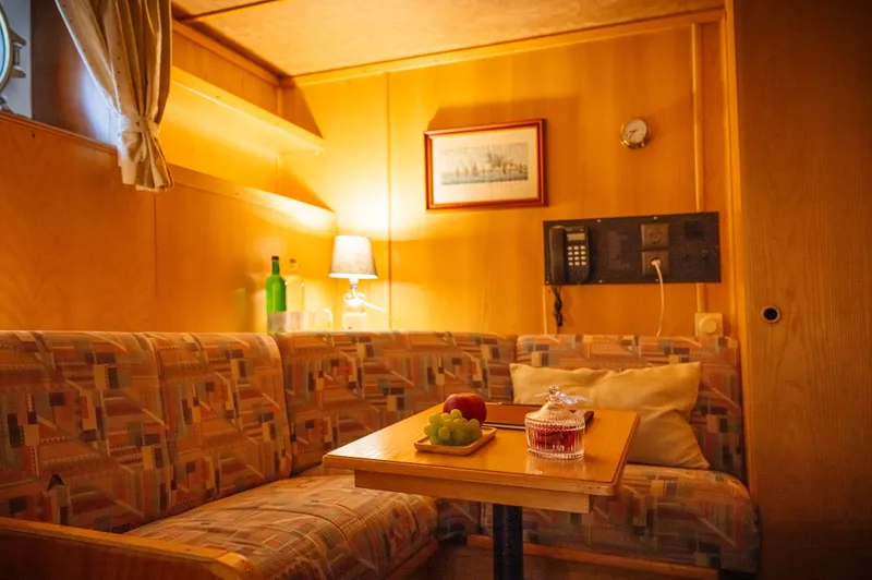 Sanssouci Star Yacht Photos Pics Cozy 1982 Custom Displacement Twin Screw yacht interior with seating, table, and warm lighting.