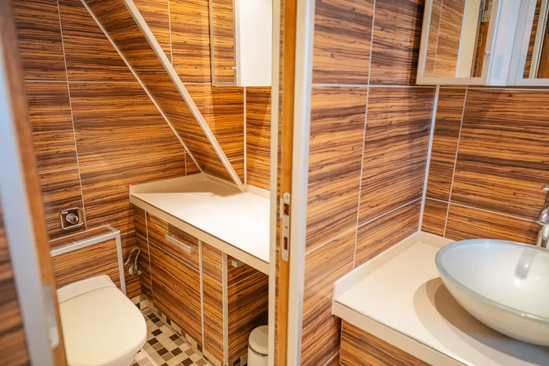 Sanssouci Star Yacht Photos Pics Modern bathroom with wood paneling, vessel sink, and compact design on a 1982 Custom Displacement Twin Screw.