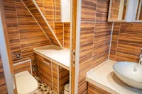 Modern bathroom with wood paneling, vessel sink, and compact design on a 1982 Custom Displacement Twin Screw.