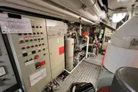 Engine room of 1982 Custom Displacement Twin Screw with control panels and machinery.