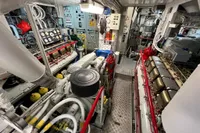Engine room of 1982 Custom Displacement Twin Screw vessel, showcasing machinery and control panels.