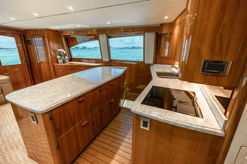 Miss Virginia Yacht Photos Pics Luxurious kitchen interior of 2017 Viking 66 Convertible yacht with modern appliances and ocean view.