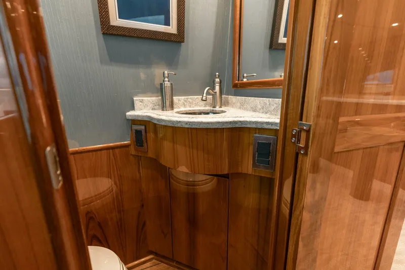 Miss Virginia Yacht Photos Pics Luxurious bathroom in 2017 Viking 66 Convertible yacht with wooden cabinetry and modern fixtures.
