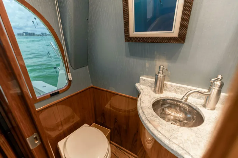Miss Virginia Yacht Photos Pics Luxurious bathroom in 2017 Viking 66 Convertible yacht with ocean view window.
