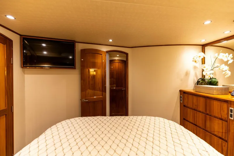 Miss Virginia Yacht Photos Pics Luxurious interior of 2017 Viking 66 Convertible yacht bedroom with TV and elegant decor.