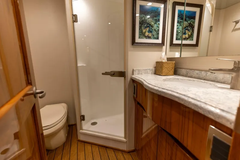 Miss Virginia Yacht Photos Pics Luxurious bathroom in 2017 Viking 66 Convertible yacht with shower and elegant wood finishes.