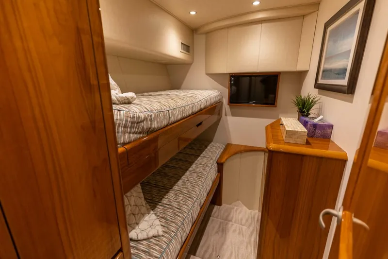 Miss Virginia Yacht Photos Pics Interior of 2017 Viking 66 Convertible yacht with cozy bunk beds and elegant wood finish.