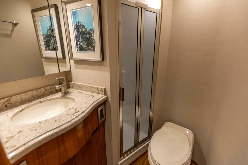 Miss Virginia Yacht Photos Pics Luxurious bathroom in 2017 Viking 66 Convertible yacht with shower, sink, and toilet.