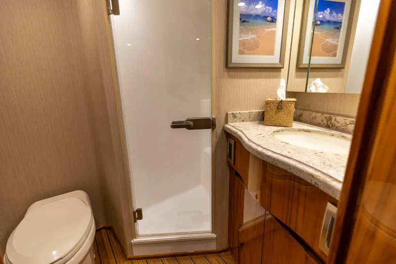 Miss Virginia Yacht Photos Pics Luxurious bathroom in 2017 Viking 66 Convertible yacht with shower, sink, and toilet.