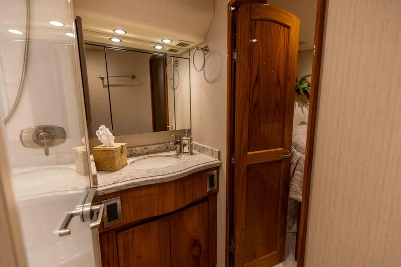 Miss Virginia Yacht Photos Pics Luxurious bathroom in 2017 Viking 66 Convertible yacht with wooden accents and modern fixtures.