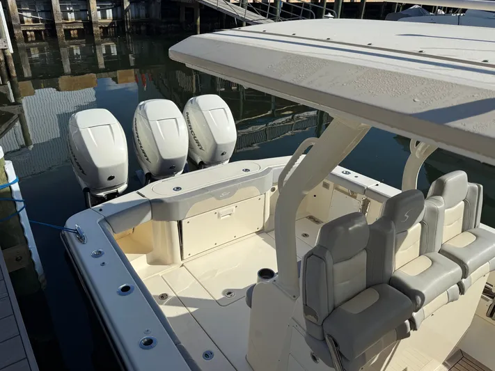 Giddy Up Yacht Photos Pics 2019 Scout 355 LXF CC boat with triple Mercury engines docked in marina.