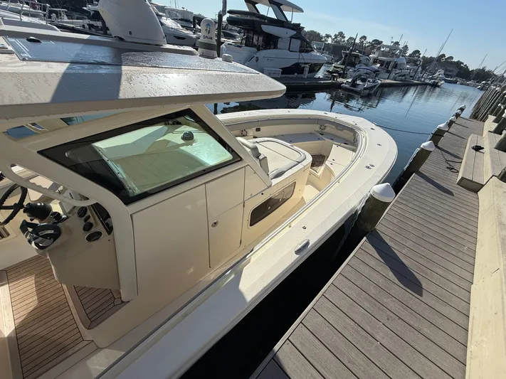 Giddy Up Yacht Photos Pics 2019 Scout 355 LXF CC boat docked at marina, sunny day, luxury vessel.