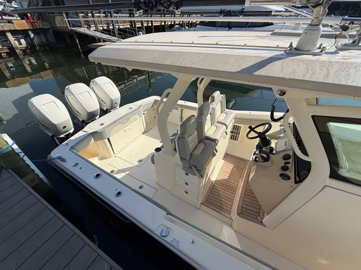 Giddy Up Yacht Photos Pics 2019 Scout 355 LXF CC boat with triple outboard engines docked at marina.