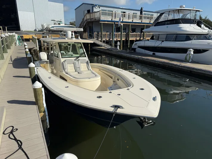Giddy Up Yacht Photos Pics 2019 Scout 355 LXF CC boat docked at marina, featuring sleek design and modern amenities.