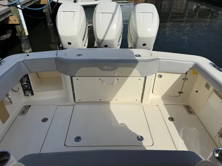 Giddy Up Yacht Photos Pics 2019 Scout 355 LXF CC boat with triple outboard engines at dock.