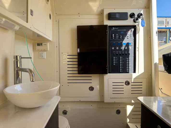 Giddy Up Yacht Photos Pics 2019 Scout 355 LXF CC boat interior with sink and control panel.