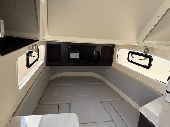 Giddy Up Yacht Photos Pics 2019 Scout 355 LXF CC cabin interior with seating and windows.