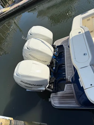 Giddy Up Yacht Photos Pics 2019 Scout 355 LXF CC boat with triple Mercury outboard engines docked in water.