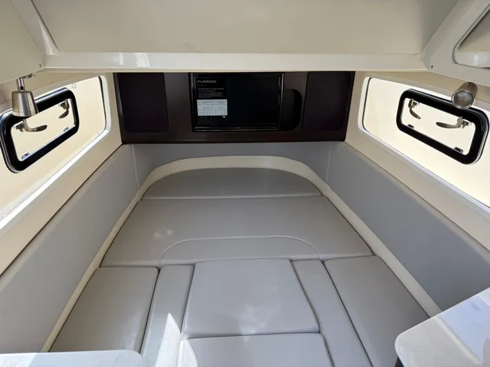 Giddy Up Yacht Photos Pics 2019 Scout 355 LXF CC cabin interior with cushioned seating and windows.