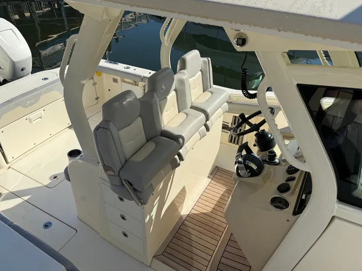 Giddy Up Yacht Photos Pics 2019 Scout 355 LXF CC boat interior with helm and seating area.