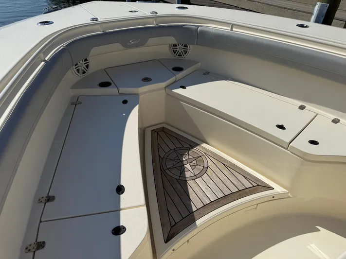 Giddy Up Yacht Photos Pics 2019 Scout 355 LXF CC boat interior with cushioned seating and storage compartments.