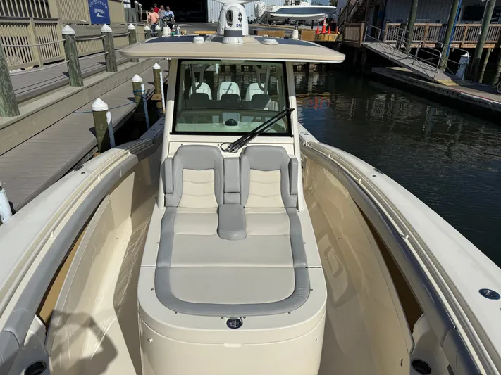 Giddy Up Yacht Photos Pics 2019 Scout 355 LXF CC boat docked, featuring spacious seating and sleek design.