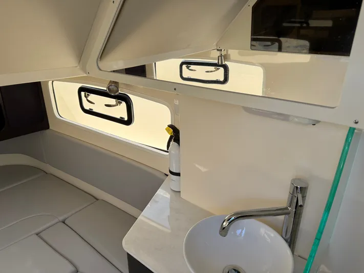 Giddy Up Yacht Photos Pics 2019 Scout 355 LXF CC cabin interior with sink and seating area.