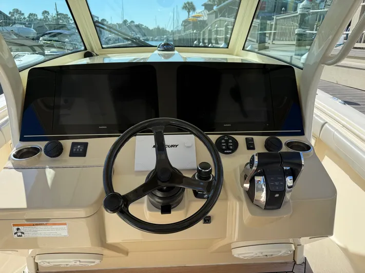Giddy Up Yacht Photos Pics 2019 Scout 355 LXF CC boat helm with steering wheel and controls.