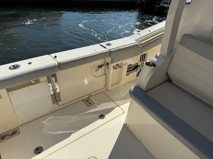 Giddy Up Yacht Photos Pics 2019 Scout 355 LXF CC boat interior with seating and water view.