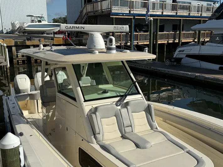 Giddy Up Yacht Photos Pics 2019 Scout 355 LXF CC boat docked, featuring Garmin radar and luxurious seating.