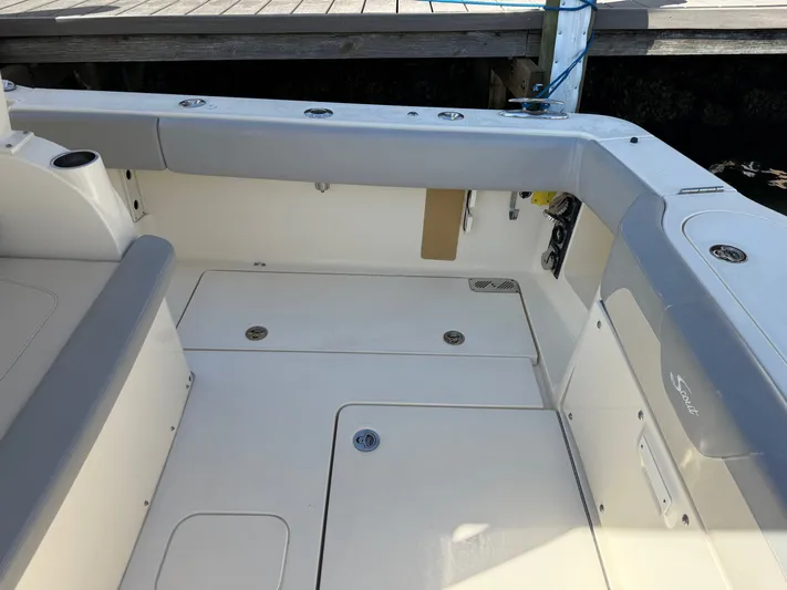 Giddy Up Yacht Photos Pics 2019 Scout 355 LXF CC boat interior with seating and storage compartments.